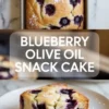 Blueberry olive oil snack cake in a loaf pan with a plated slice showing juicy blueberries and a tender pale crumb.