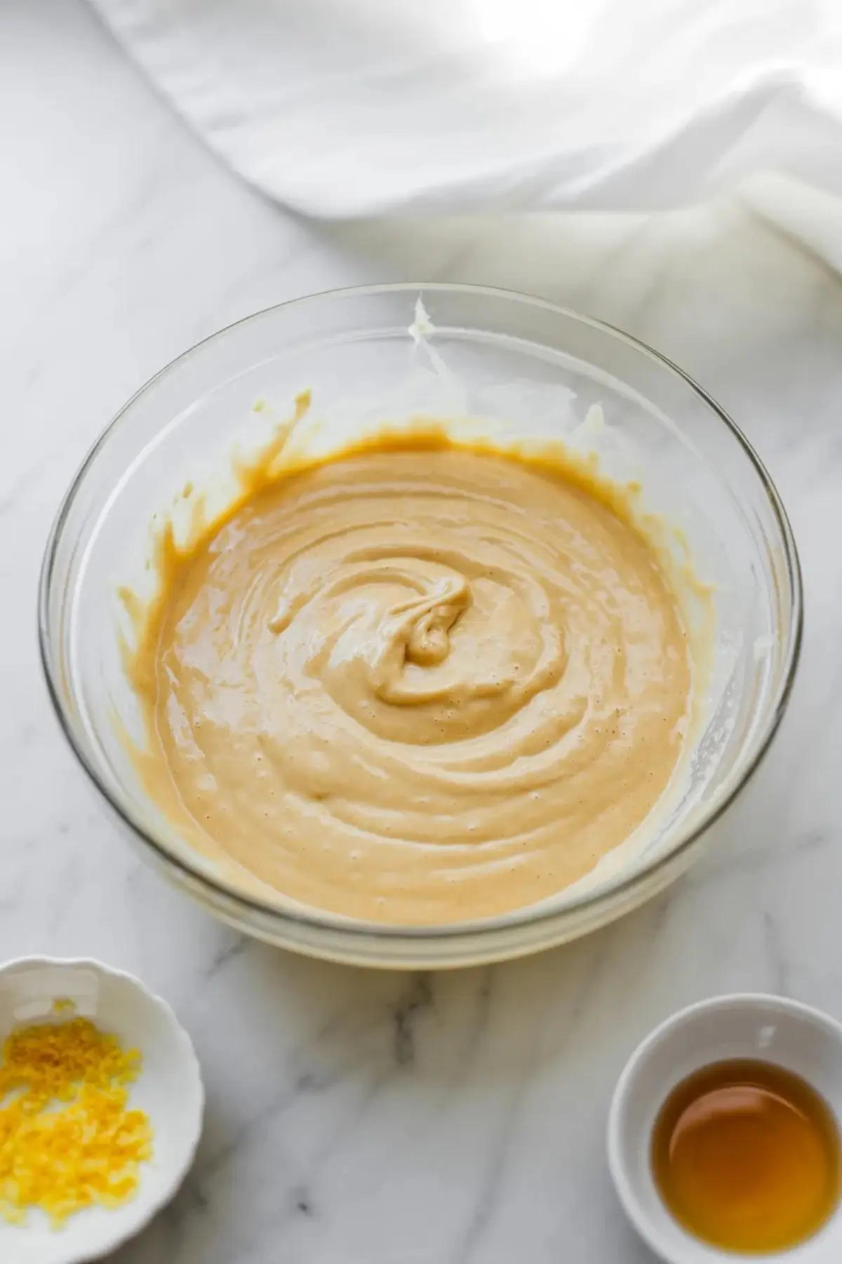 Eggs and sugar being whisked together in a bowl for blueberry olive oil snack cake.