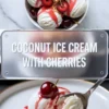 Coconut ice cream shown in a 2 to 3 hero image with a bowl of scoops above and one plated scoop with cherry sauce below.