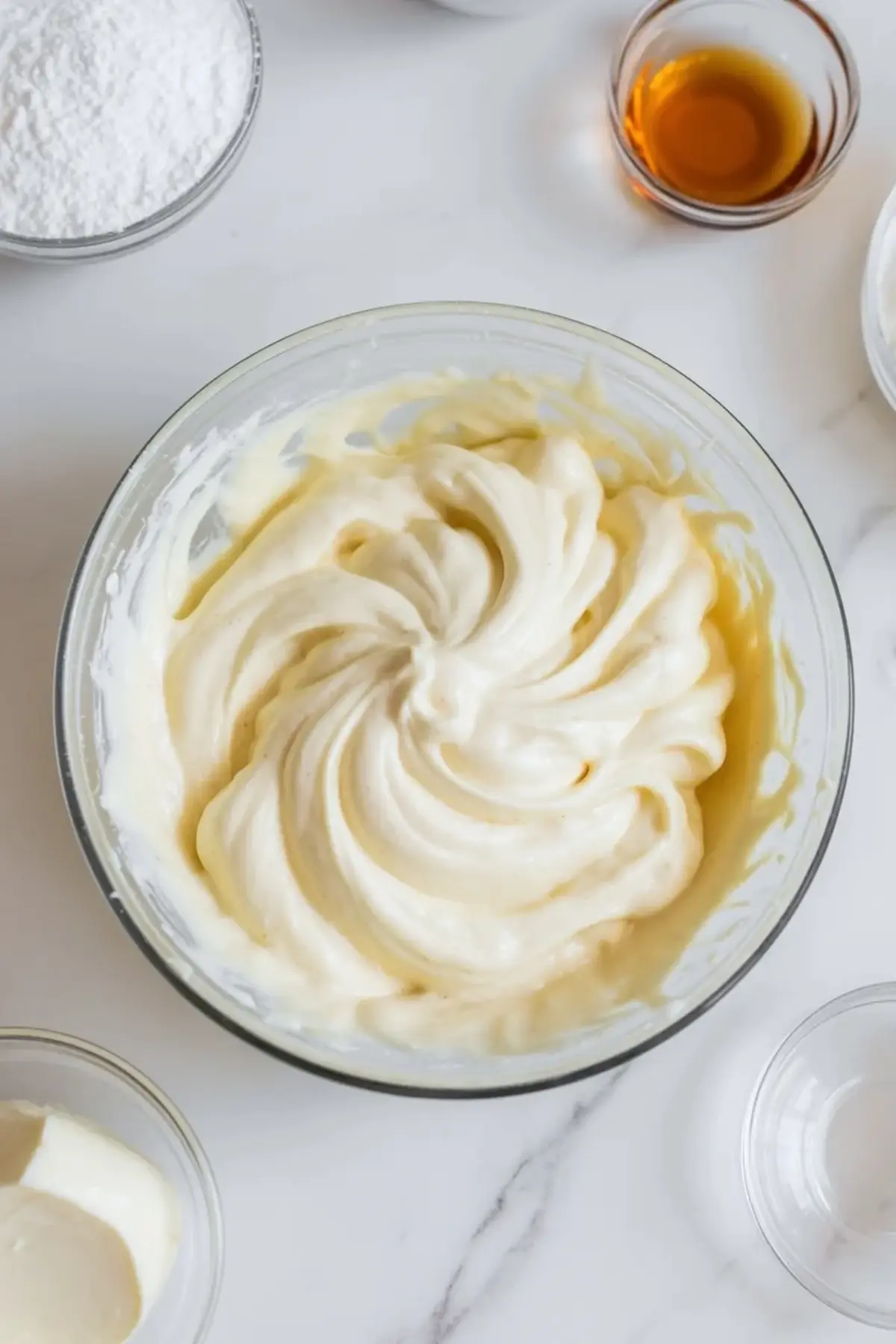Smooth cream cheese filling for orange creamsicle bars is whipped in a bowl until light and creamy.