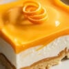 Featured orange creamsicle bars image showing one sliced bar on a plate with glossy orange topping, creamy white filling, and buttery graham crust.
