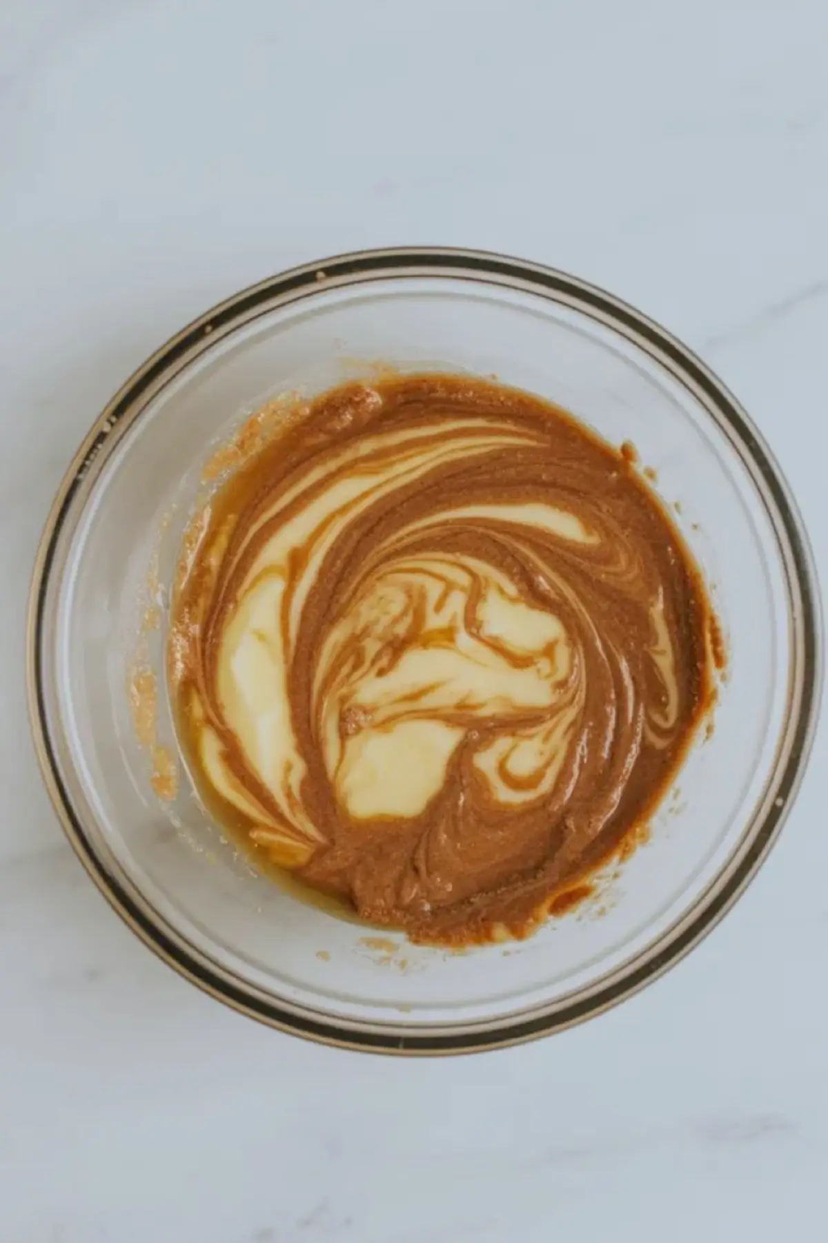 Melted butter and brown sugar being stirred together for patriotic funfetti blondie batter.