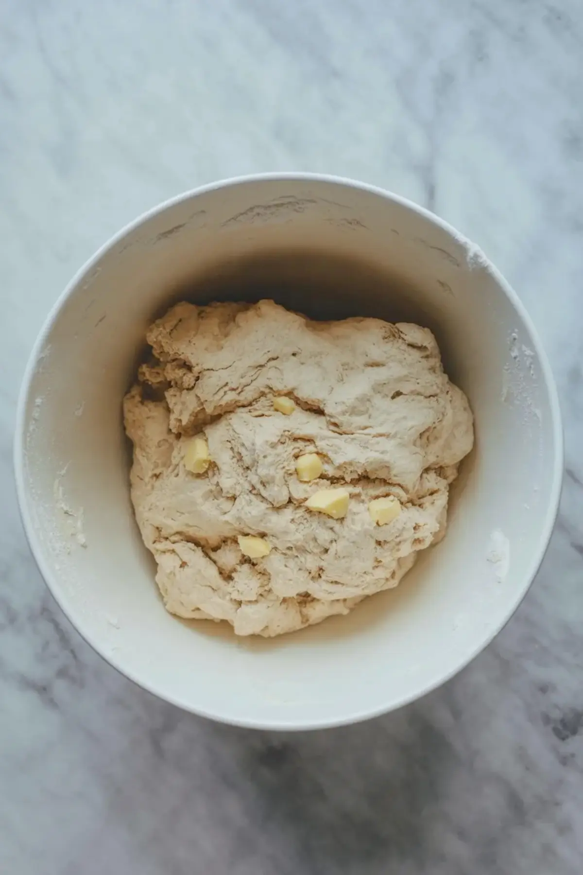 Berry galette dough mixed in a bowl with visible butter pieces before chilling.