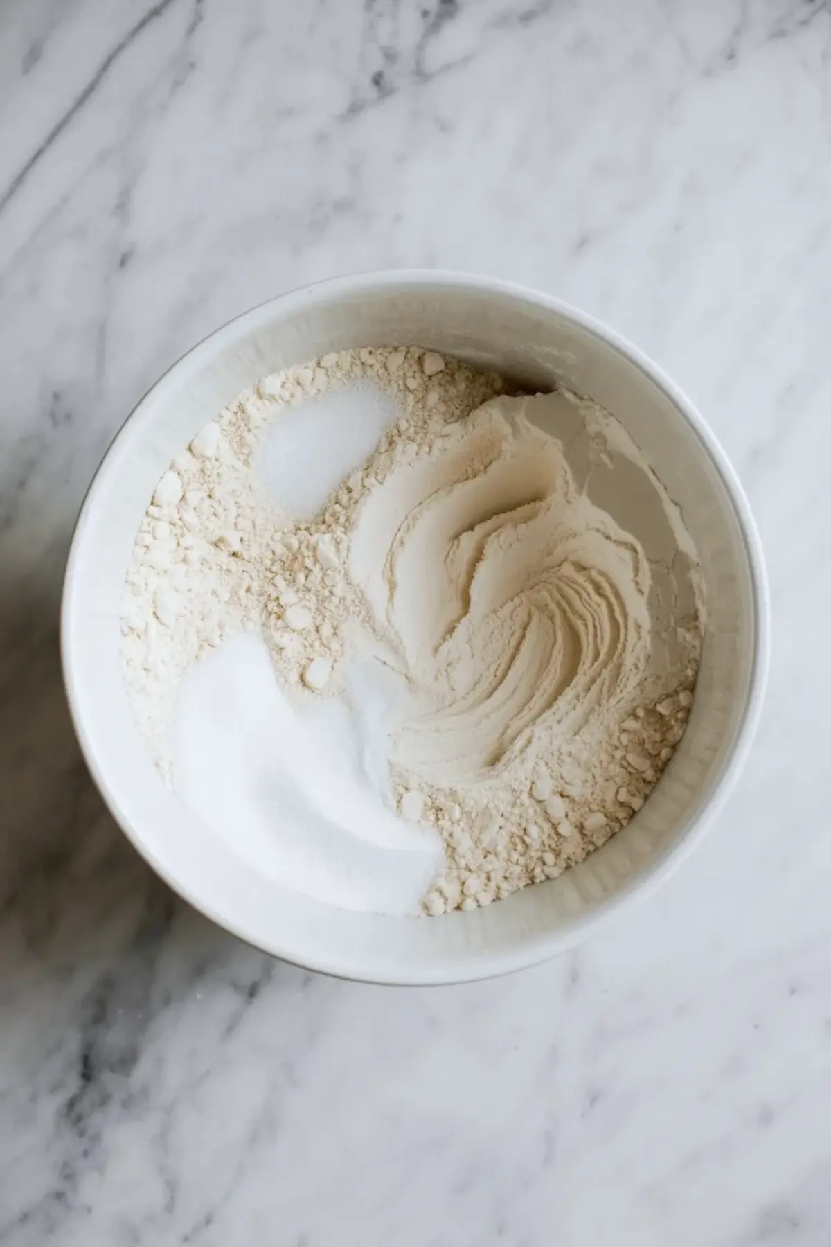 Flour and sugar in a bowl for making the dough for a 4th of July berry galette.