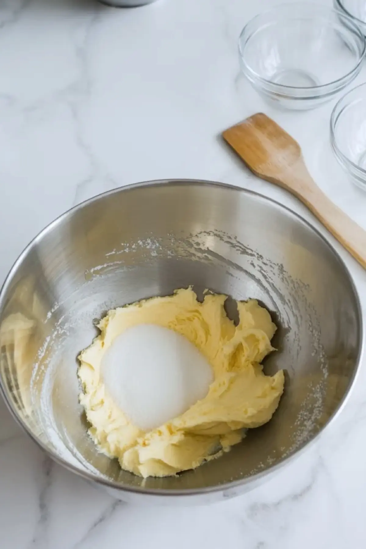 Butter and sugar being creamed together in a mixing bowl for patriotic sugar cookie bars.