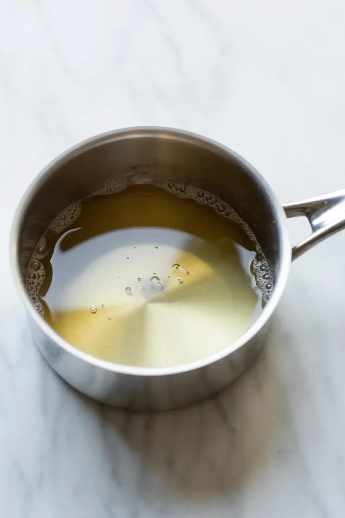 Liquid sauce base in a saucepan for pear pie filling before the pears are added.