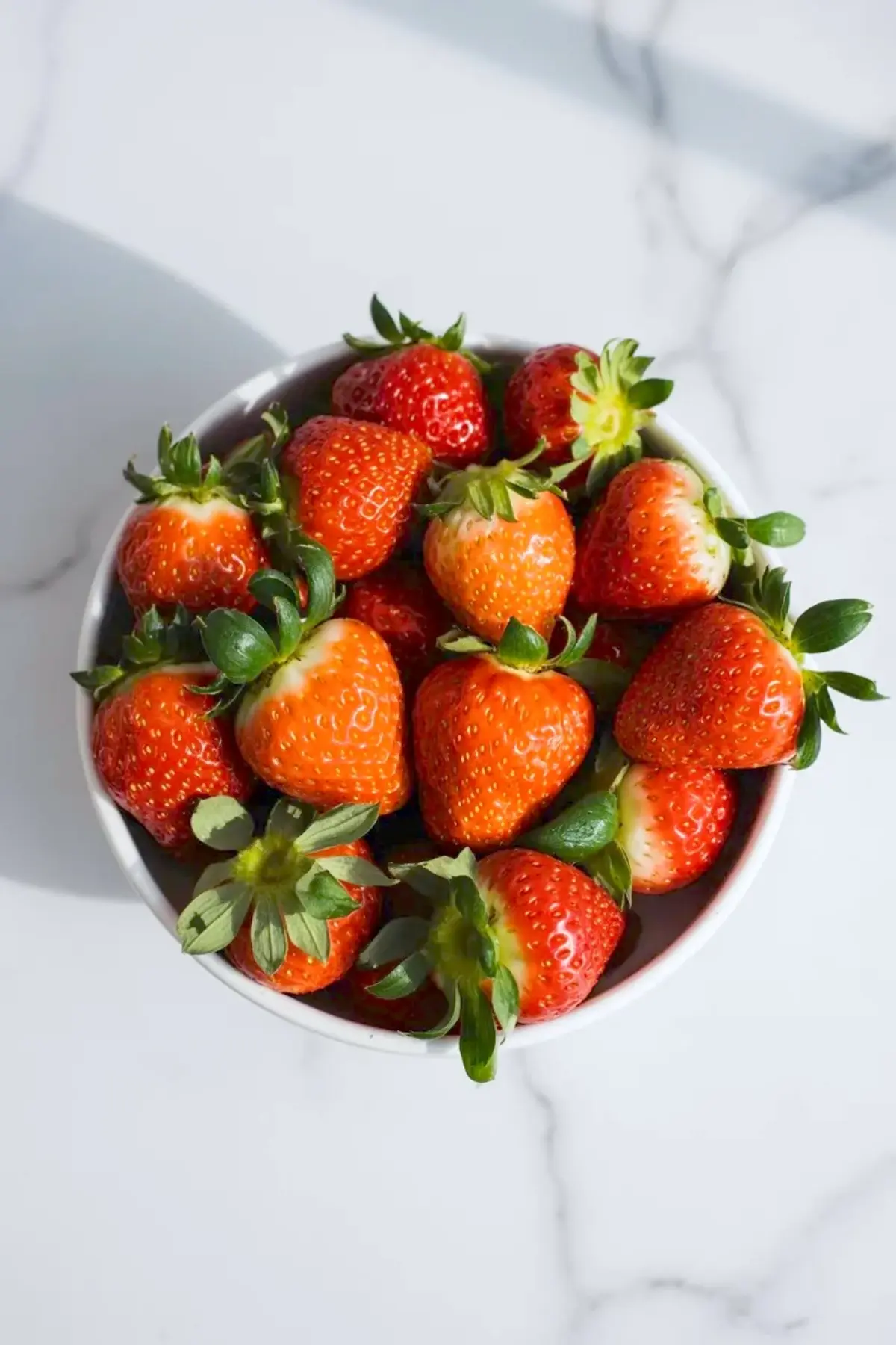 Close view of strawberry matcha croissants with flaky layers, piped matcha cream, and fresh sliced strawberries tucked inside.