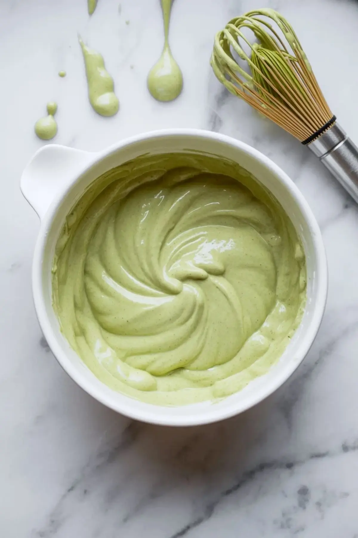 Matcha cream filling being mixed in a bowl for strawberry matcha croissants until smooth, thick, and light green.