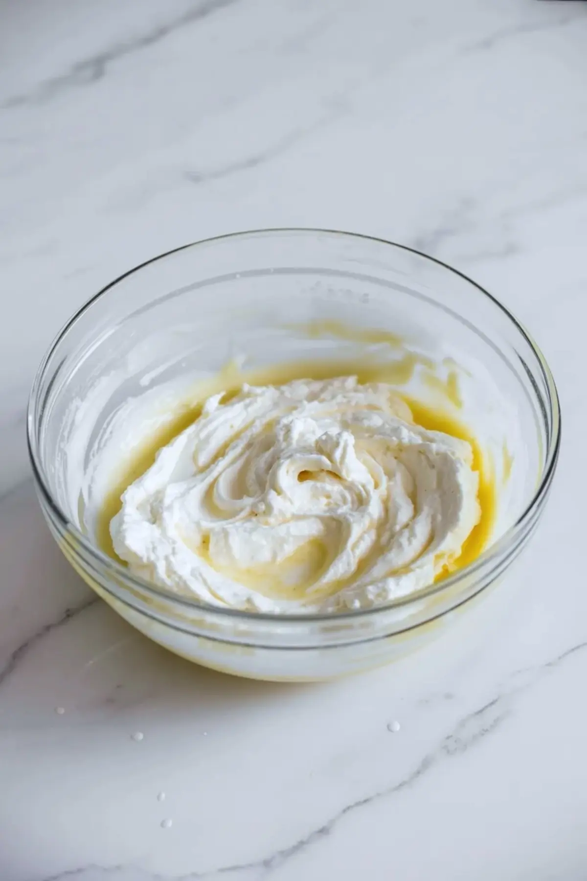 Ricotta cheesecake filling in a glass bowl for strawberry cheesecake cups, showing the smooth creamy texture before assembly.