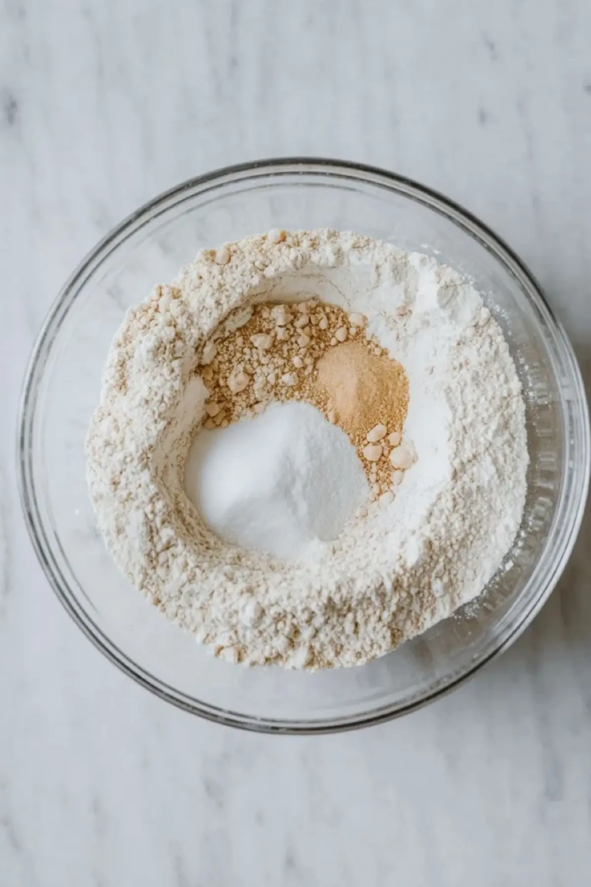 Dry ingredients for blueberry sour cream coffee cake are whisked together in a bowl before mixing the batter.