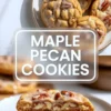 Maple pecan cookies with maple glaze are stacked on a plate with a broken cookie showing the soft center and toasted pecans.