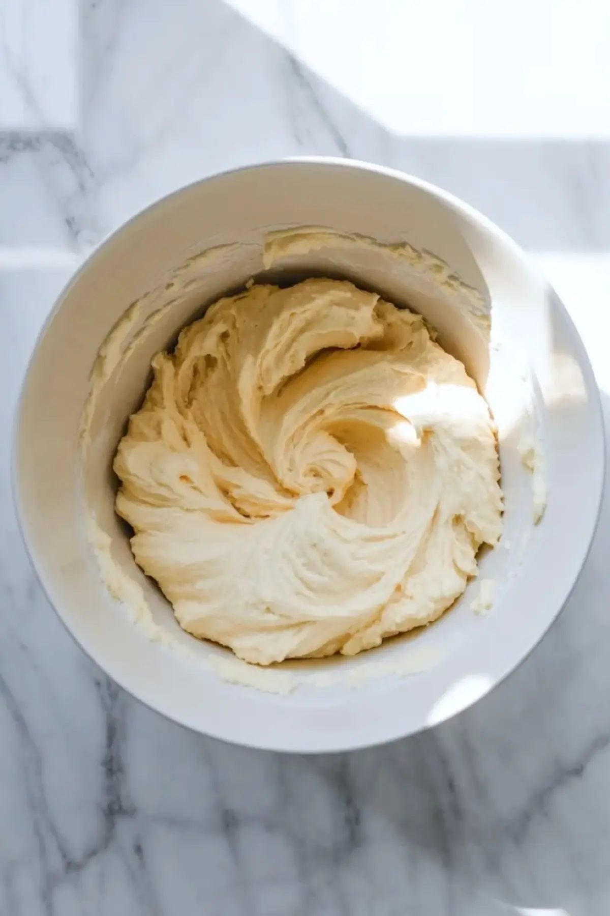Smooth whoopie pie batter sits in a mixing bowl before it is divided and colored for patriotic whoopie pies.