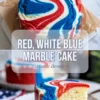Finished red white and blue marble cake with a glazed top and one sliced piece showing the patriotic swirl pattern inside.