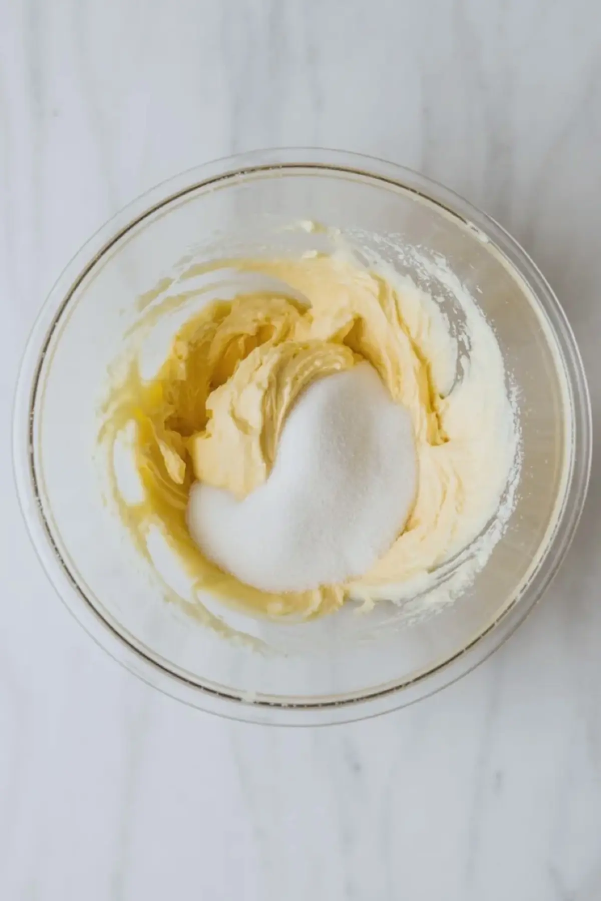 Butter and sugar are mixed in a bowl to start the fudgy brownie base for star-spangled brownies.