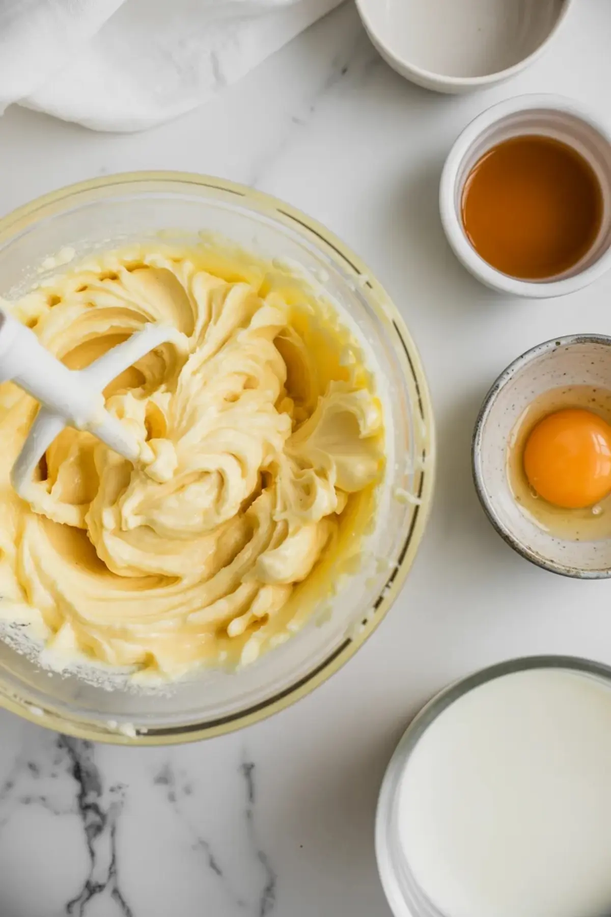 Creamed butter and sugar mixture for strawberry marshmallow cookies in a mixing bowl before the dough is finished.