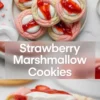Strawberry marshmallow cookies hero image with pink and vanilla cookies topped with marshmallow centers, strawberry glaze, and sliced strawberries over title text.