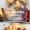 Cranberry orange scones hero graphic with glazed golden scones on a white plate, orange zest garnish, and a split scone showing the soft crumb and cranberries.