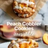 Peach cobbler cookies with vanilla glaze, crumb topping, and a split cookie showing soft peach filling inside.