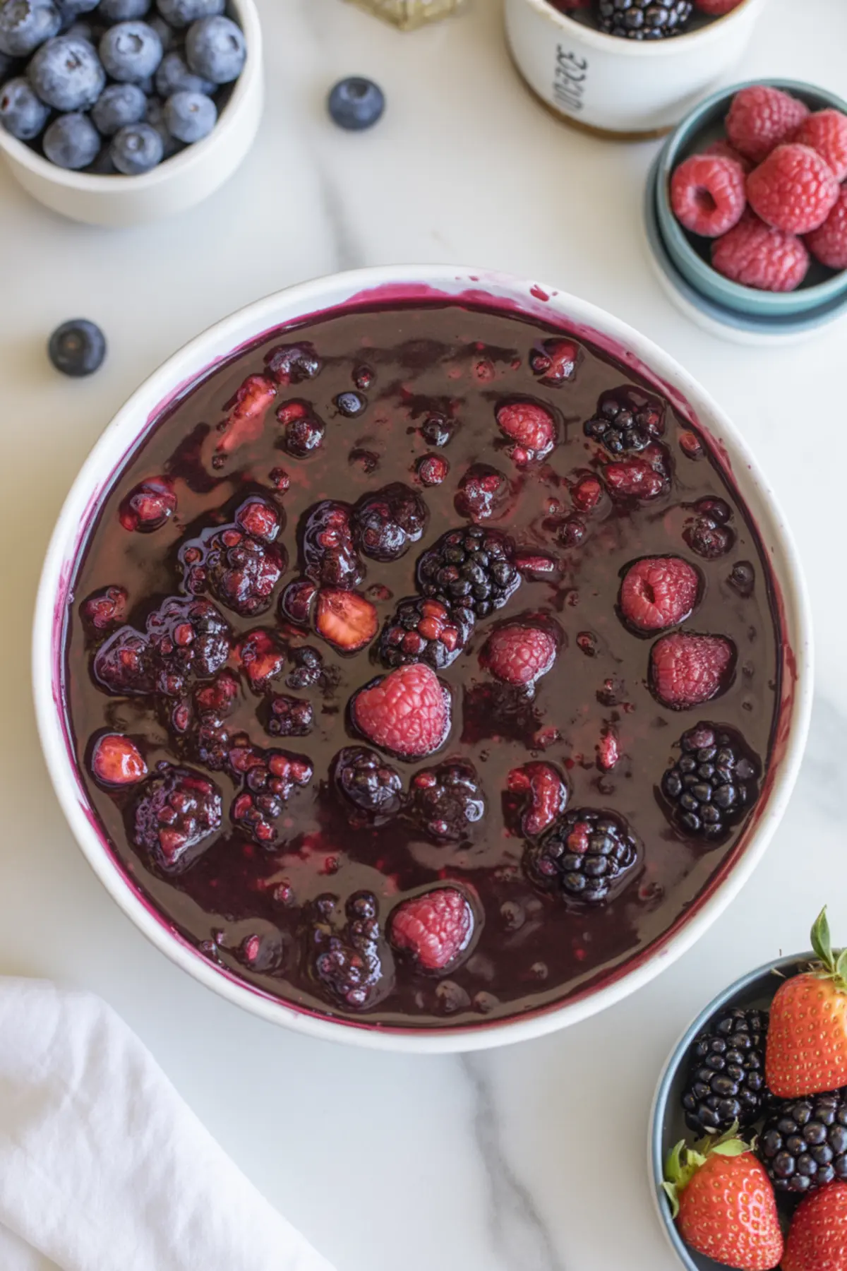 Glossy mixed berry filling with blueberries, raspberries, blackberries, and strawberries for wild berry Pop Tarts.